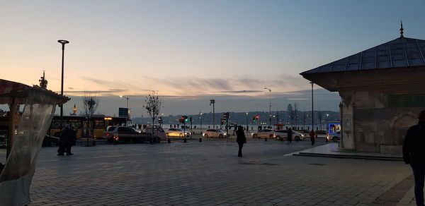 People on street in city at sunset