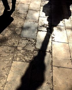 Shadow of person on footpath