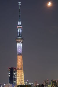 Low angle view of illuminated tower at night