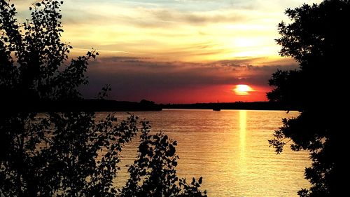 Scenic view of lake against sky during sunset