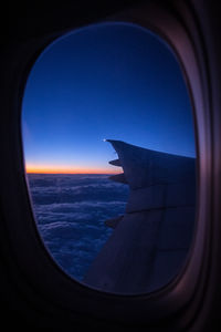 Airplane flying over sea seen through window