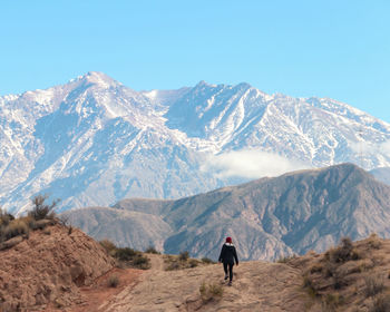 Rear view of man standing on mountain