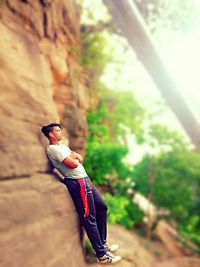 Side view of man climbing on rock
