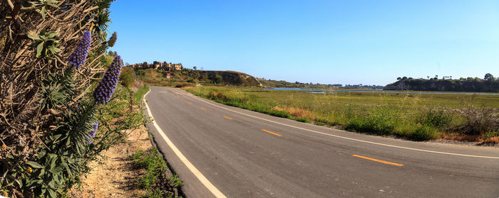 Road amidst landscape against clear sky