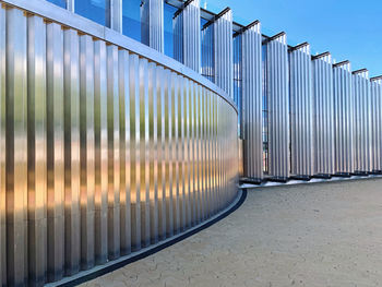 Metallic structure on footpath against building