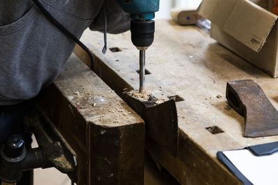 Close-up of drilling of an axe for restoration