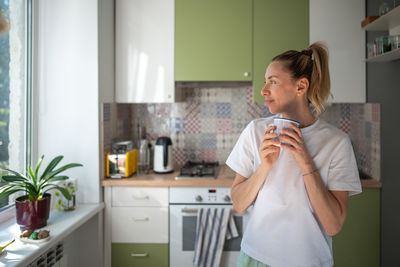 Side view of mother and daughter in bathroom