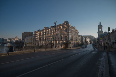 View of city buildings against clear sky