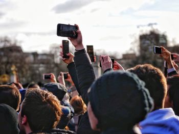 Rear view of people photographing