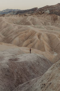 Man in desert with mountain in background