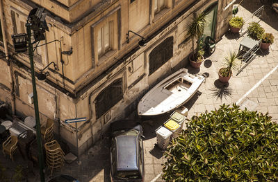 High angle view of car and boat by building