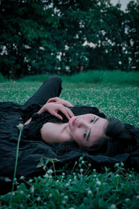 Young woman lying on field