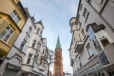 Low angle view of clock tower against sky in city