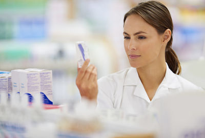 Pharmacist examining medicine in chemist