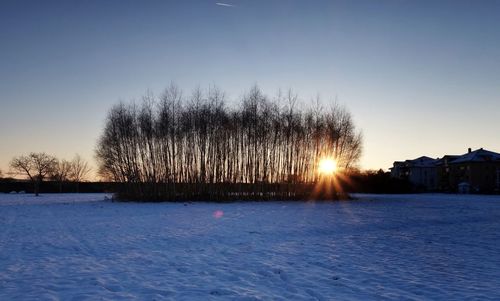 Scenic view of snow covered landscape at sunset