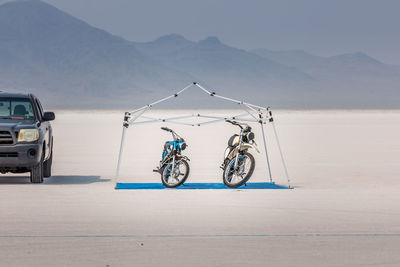 Bicycle on road against mountain range