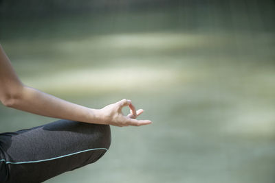 Midsection of woman with arms raised