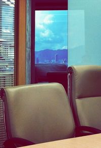 Close-up of chair against window at home