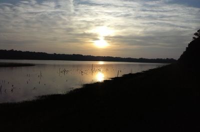 Scenic view of lake at sunset