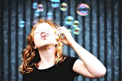 Young woman blowing bubbles