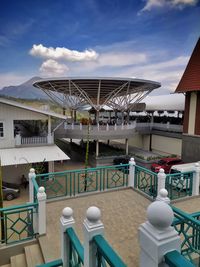 View of swimming pool by building against sky