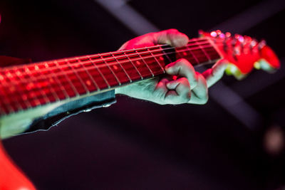 Close-up of hand playing guitar