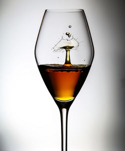 Close-up of beer glass against white background