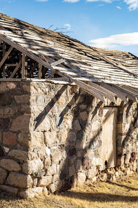 Low angle view of old stone building bathhouse at hot springs against sky