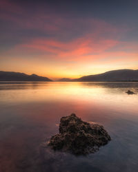 Scenic view of sea against romantic sky at sunset