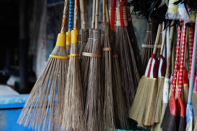 Close-up of brooms hanging for sale