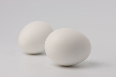 Close-up of eggs against white background