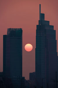 Low angle view of buildings against sky during sunset