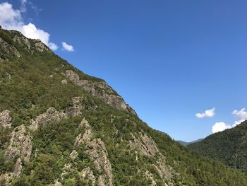 Scenic view of mountains against blue sky