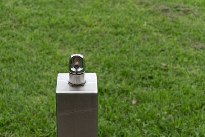 Close-up of metal container on grass