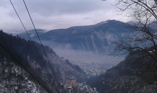 Scenic view of mountains against cloudy sky