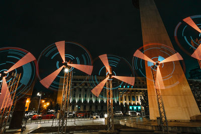 Low angle view of illuminated ferris wheel at night