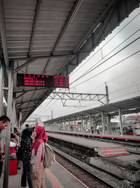 People waiting train at railroad station platform