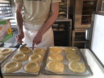 Midsection of man preparing food in kitchen