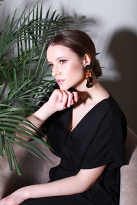 Portrait of young woman sitting on bed