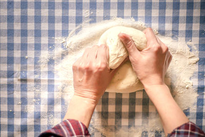 Female hands making yeast pizza dough, kneading dough for homemade bread, female hands and dough