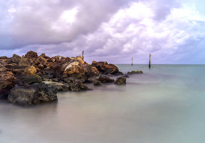 Scenic view of sea against cloudy sky