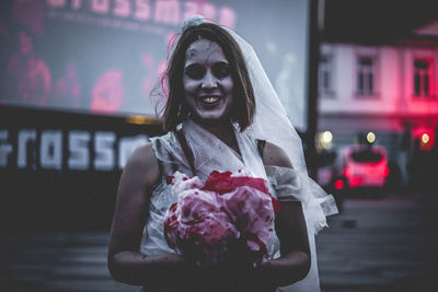 Portrait of woman holding bouquet