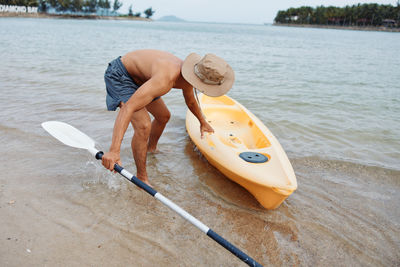 Man kayaking in sea