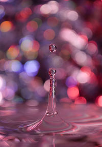 Close-up of drop falling on water