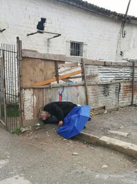 Man in front of built structure