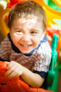 Portrait of happy boy sitting outdoors