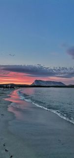 Scenic view of beach against sky during sunset