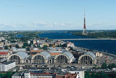 High angle view of cityscape by sea against sky