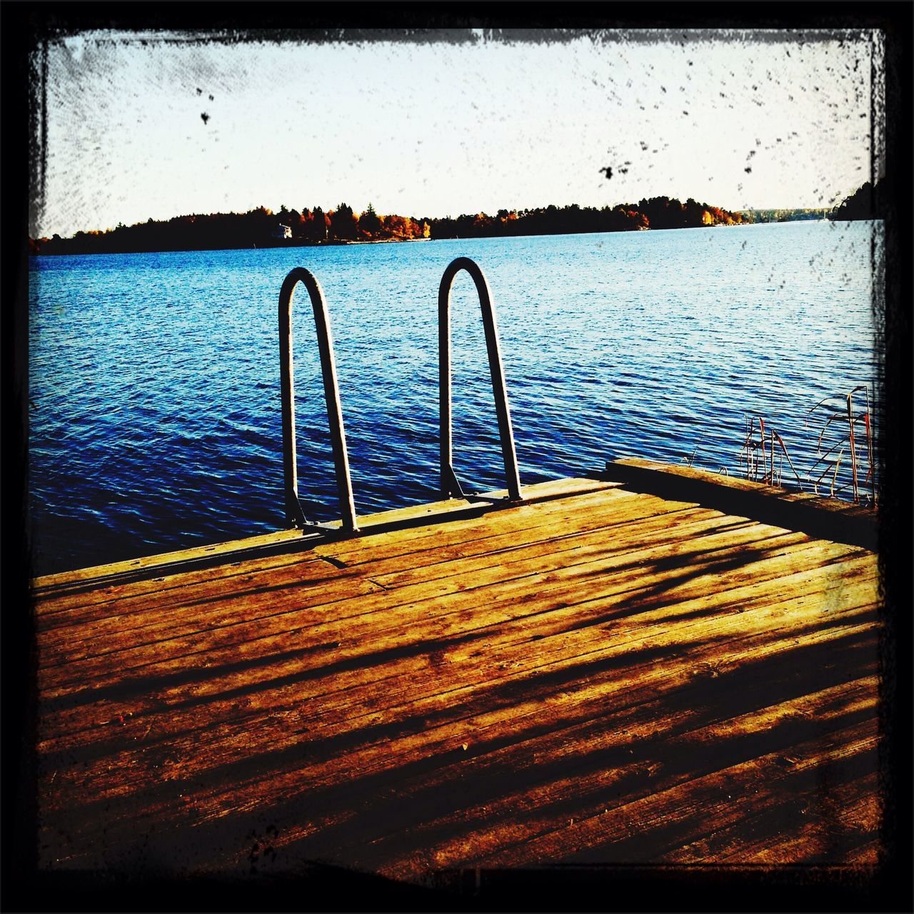 water, transfer print, railing, auto post production filter, tranquil scene, tranquility, sea, pier, lake, nature, scenics, rippled, sky, beauty in nature, river, metal, sunset, blue, wood - material, no people