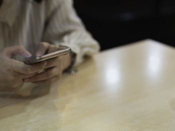 Midsection of man using mobile phone